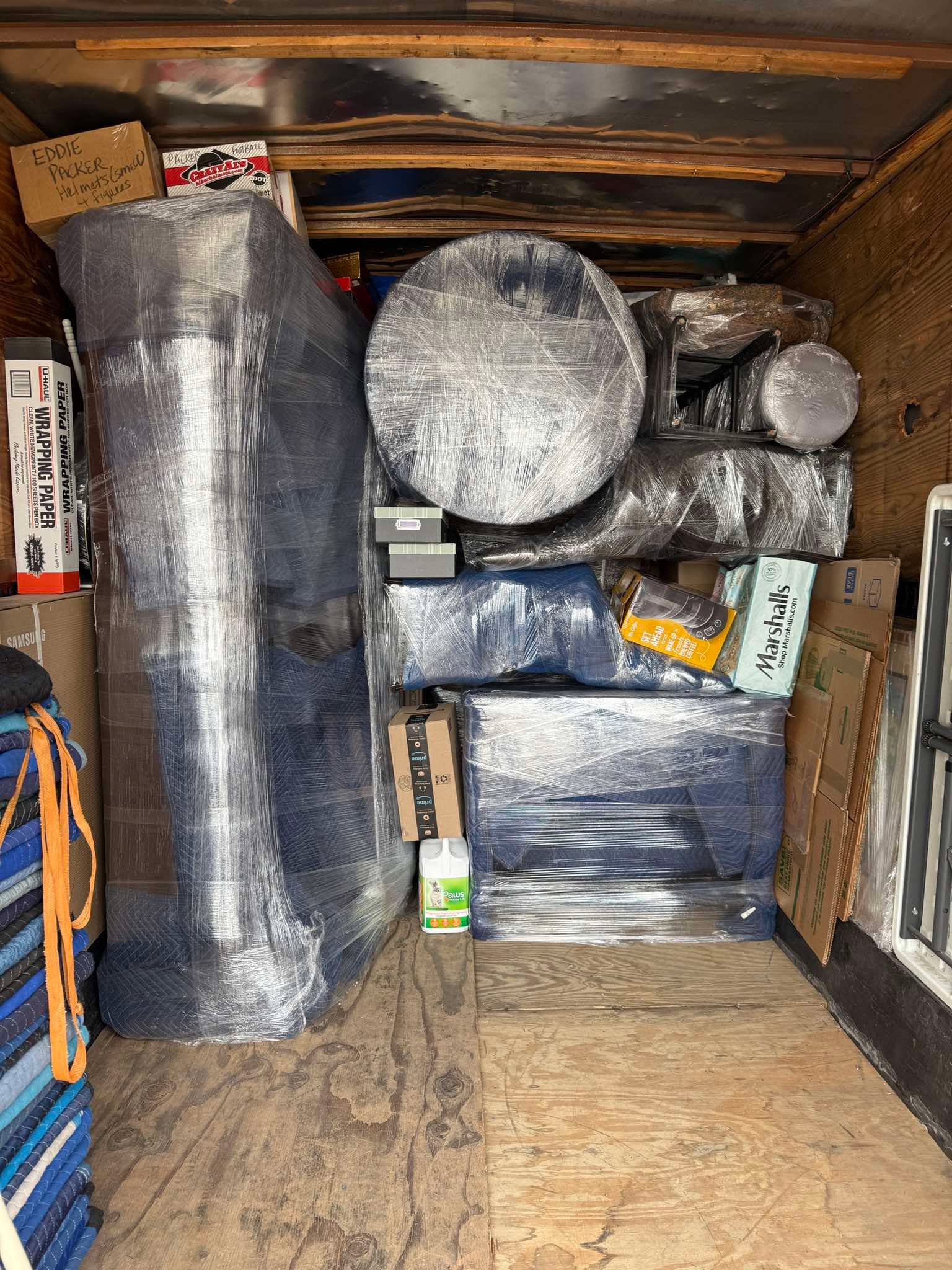 Furniture carefully stretch-wrapped inside trailer