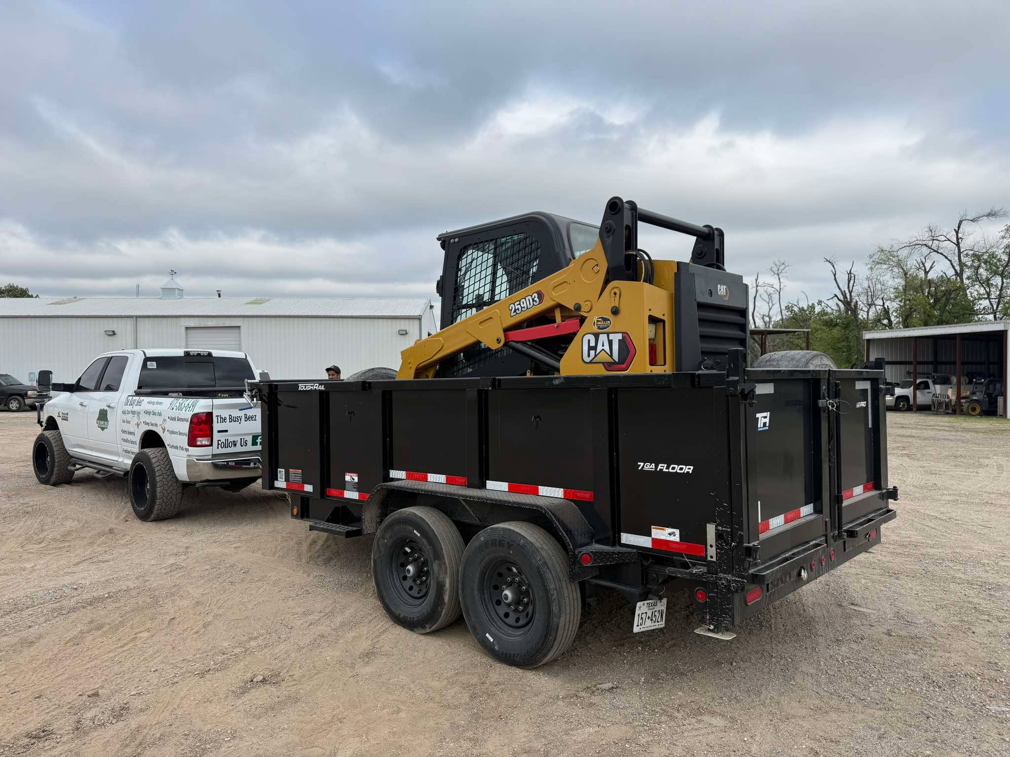 CAT compact track loader on Busy Beez dump trailer