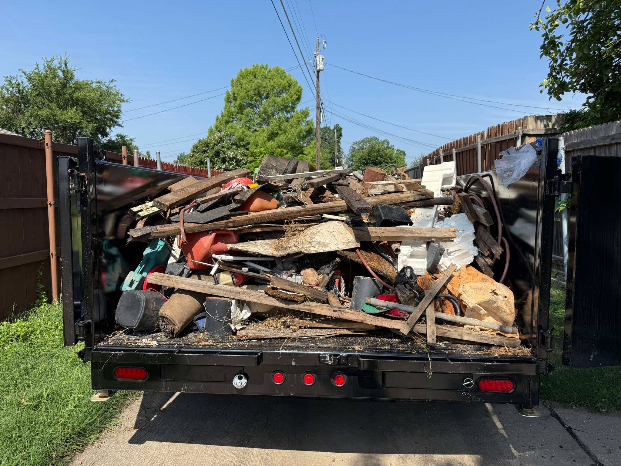 Open dump trailer loaded with demolition debris