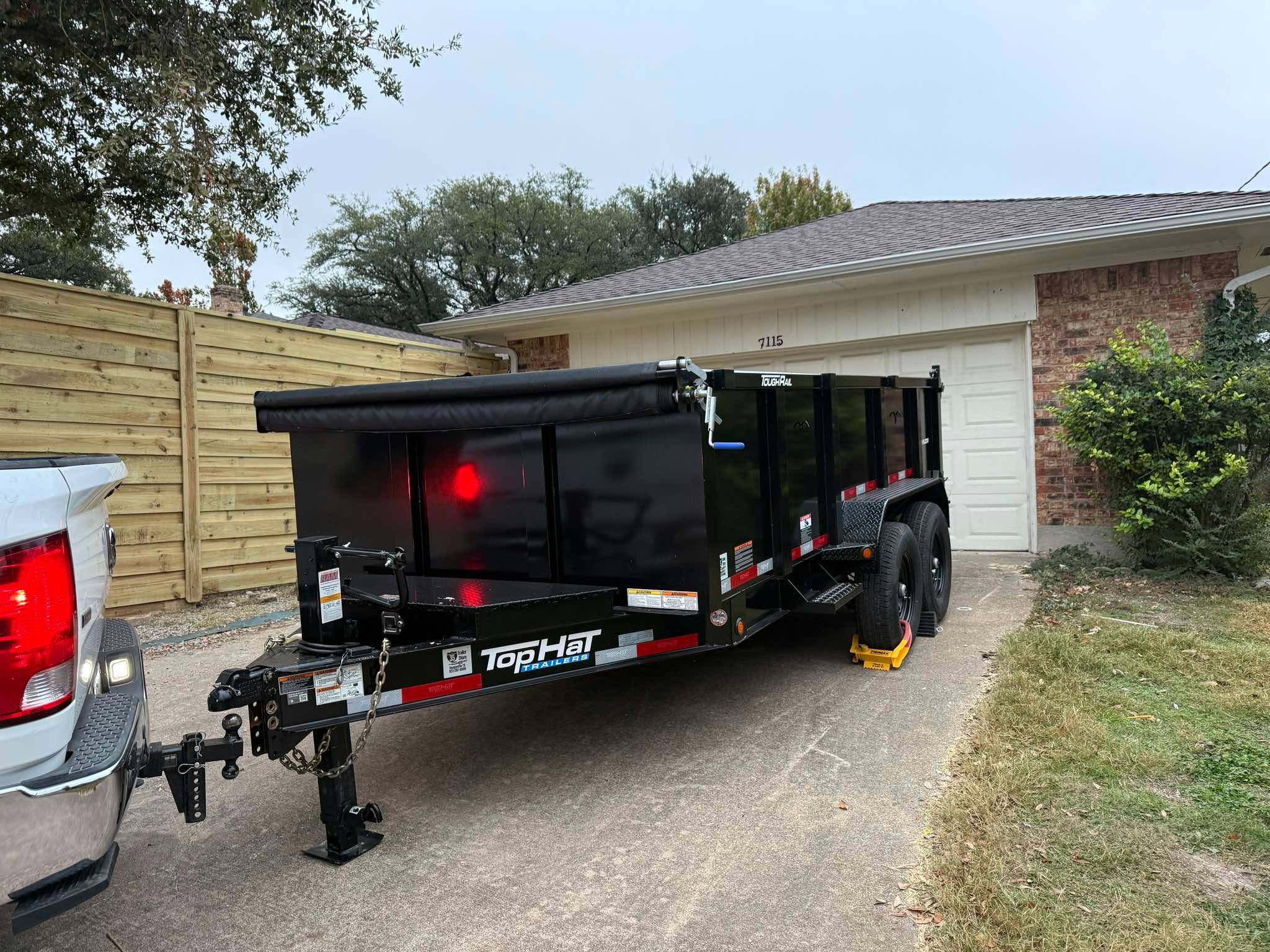 Top Hat dump trailer parked at a residential job