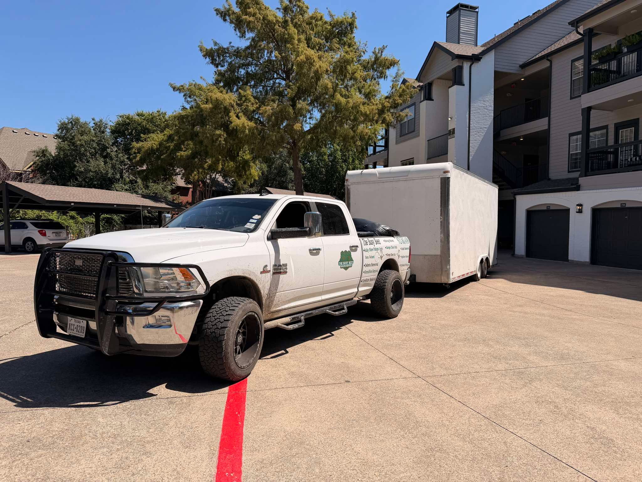 Busy Beez truck towing an enclosed cargo trailer